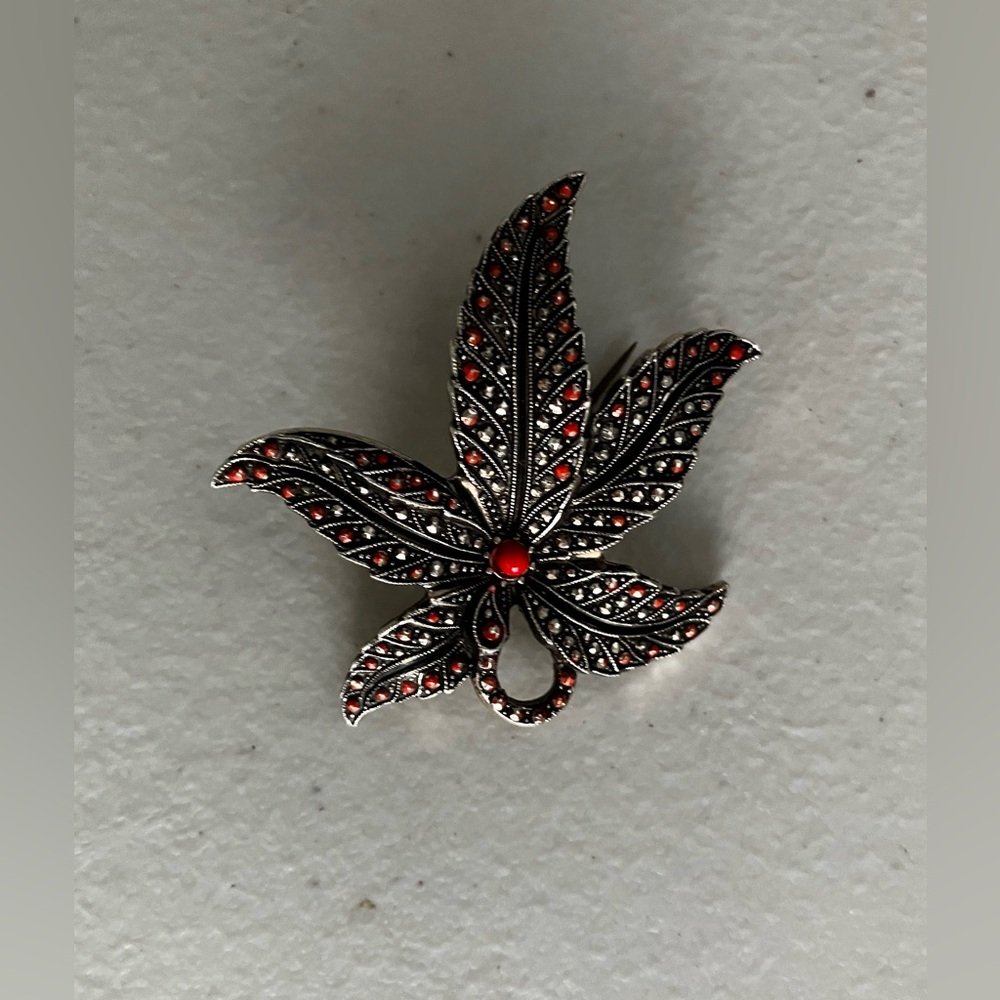 Vintage German intricate brooch maple leaf-shaped with small red crystals